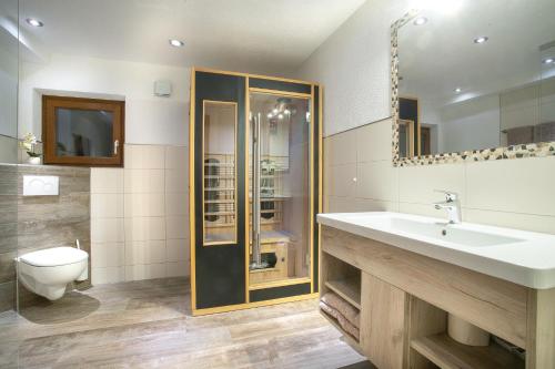 a bathroom with a sink and a toilet at Camping Inntal in Wiesing