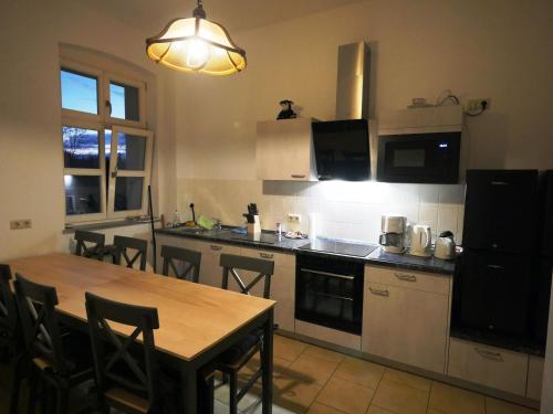 a kitchen with a table and some chairs and a table and a counter at Touristisches Begegnungzentrum Melchow in Melchow