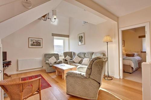 a living room with a couch and a table at Nethergill Farm in Skipton