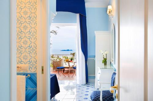 a blue and white hallway with a view of the ocean at Villa Fiorentino in Positano