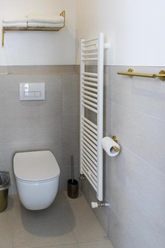 a bathroom with a toilet and a roll of toilet paper at English House in Bistriţa