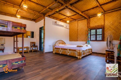 a large room with a bed and a loft at Bigfoot Stay - Forganic Farm & Agro Tourism in Khopoli