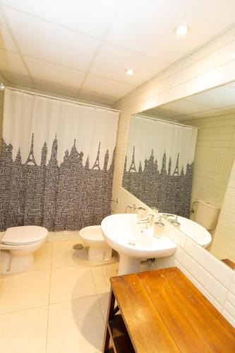 a bathroom with two toilets and a sink and a mirror at Ambar Beach Morpar Calp in Calpe