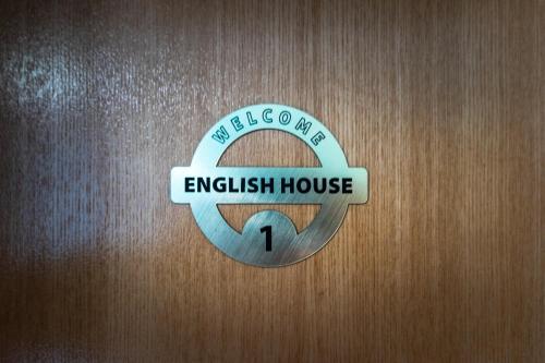 a door with a sign that reads embassy house at English House in Bistriţa