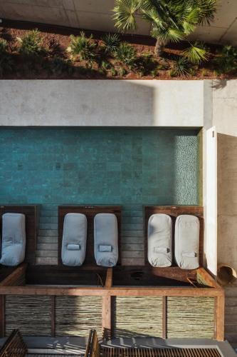 a group of white chairs sitting in a room at OKU Ibiza in San Antonio