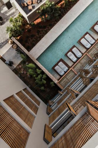 an overhead view of a swimming pool with chairs and a swimming pool at OKU Ibiza in San Antonio