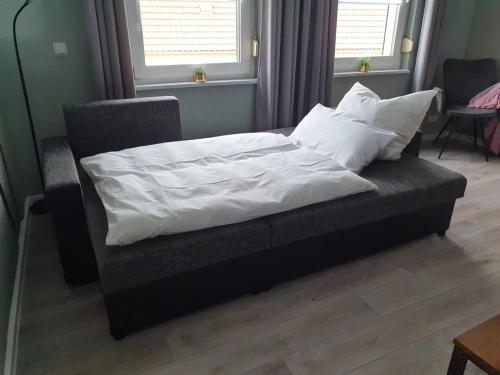 a bed with white sheets and pillows in a room at Haus Kabelitz in Kabelitz