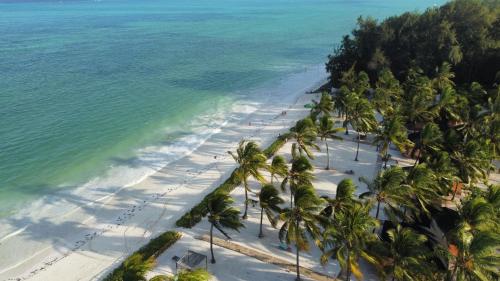 an aerial view of a beach with palm trees at VRclub Paje Palms Beach Resort in Paje