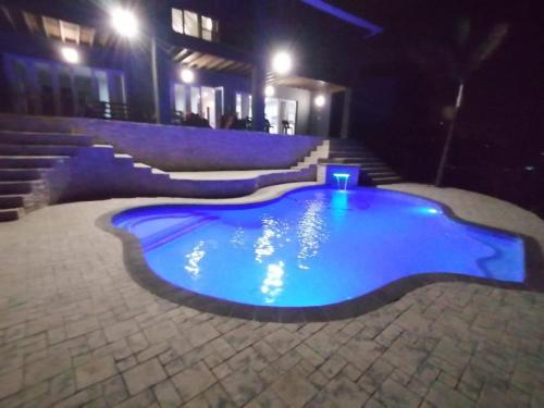 a swimming pool at night with stairs and lights at Seaside Retreat- Main House in Durban
