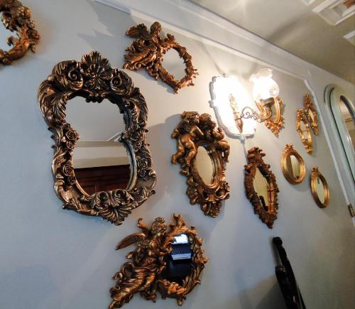 a group of mirrors hanging on a wall at Casa Nives in San Pietro in Casale