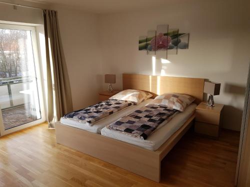 a bedroom with a bed and a large window at Fewo Dresden-Trachau in Dresden