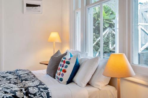 a bedroom with a bed with pillows and a window at Classic Villa Retreat - Steps To Ponsonby Rd in Auckland