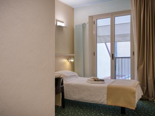 Ένα ή περισσότερα κρεβάτια σε δωμάτιο στο Hotel Piroscafo