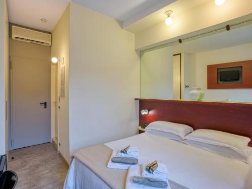 Ένα ή περισσότερα κρεβάτια σε δωμάτιο στο Hotel Piroscafo