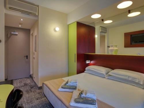 Ένα ή περισσότερα κρεβάτια σε δωμάτιο στο Hotel Piroscafo