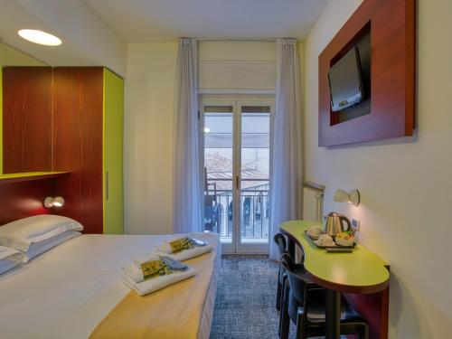 Ένα ή περισσότερα κρεβάτια σε δωμάτιο στο Hotel Piroscafo
