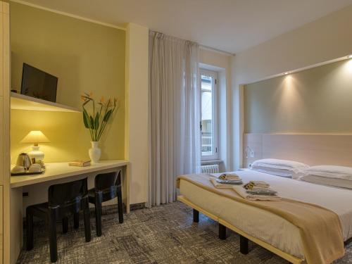 Ένα ή περισσότερα κρεβάτια σε δωμάτιο στο Hotel Piroscafo