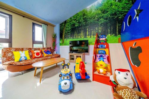 a living room with a couch and toys in it at Wonderful Land B&B in Dayin