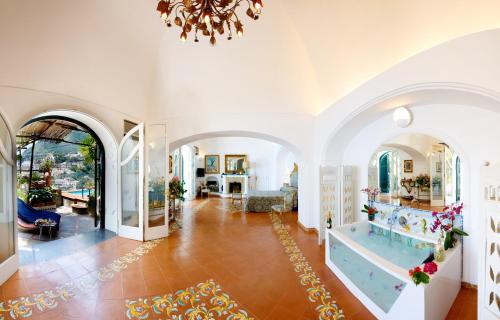 a large living room with a chandelier at Villa Fiorentino in Positano