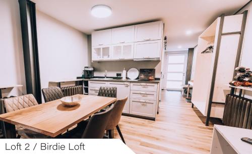 a kitchen and dining room with a wooden table and chairs at Events and Stay in Neustadt/Harz