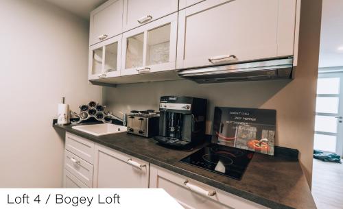 a kitchen with white cabinets and a counter top at Events and Stay in Neustadt/Harz