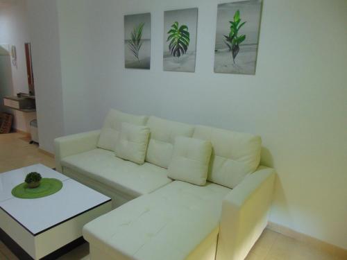 a living room with a white couch and a table at Apartamentos varios con 2 dorm en Marina Dor , la playa de Amplaries 47 , vista lateral al mar in Oropesa del Mar