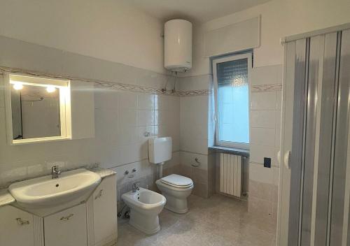 a white bathroom with a sink and a toilet at HOME SALENTO in Taviano