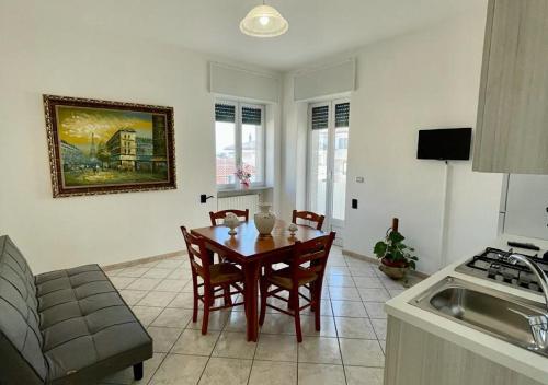 a kitchen with a table and chairs in a room at HOME SALENTO in Taviano