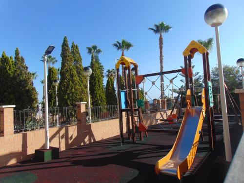 a playground with a slide in a park at Apartamentos varios con 2 dorm en Marina Dor , la playa de Amplaries 47 , vista lateral al mar in Oropesa del Mar