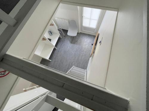 an overhead view of a staircase in a room at L'IDEAL 9 (hypercentre avec terrasse) in Deauville