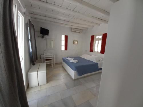 a bedroom with a bed and a chair in a room at Anezina Village in Drios