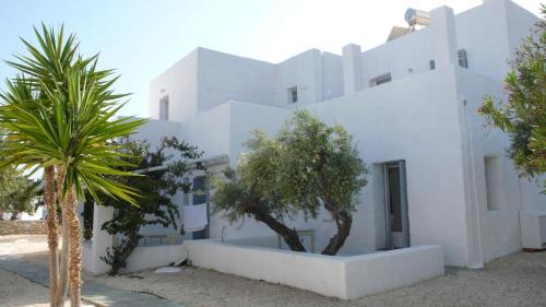 a white building with trees in front of it at Anezina Village in Drios