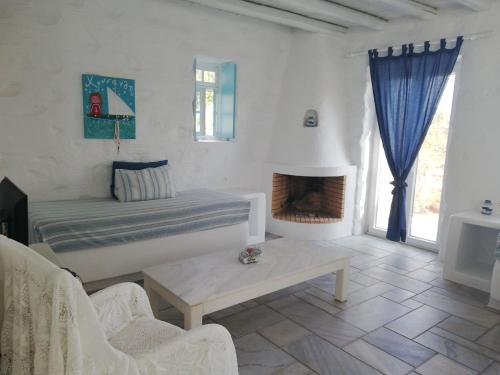 a living room with a bed and a fireplace at Anezina Village in Drios