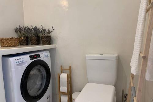 a washing machine in a bathroom with a toilet at Ευημερία in Andros