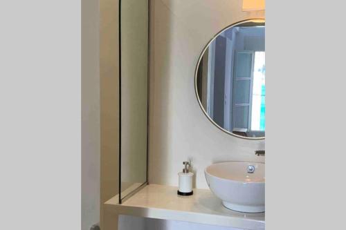 a bathroom with a sink and a mirror at Ευημερία in Andros