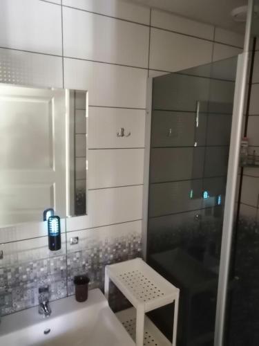 a bathroom with a sink and a mirror at Apartment by the park in Imatra
