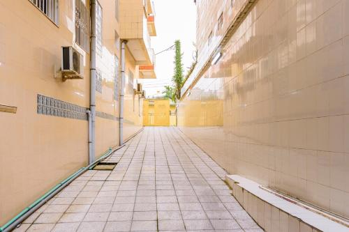 an empty alleyway between buildings in a city at RÉSIDENCE DOLCE VITA - BONANJO in Douala