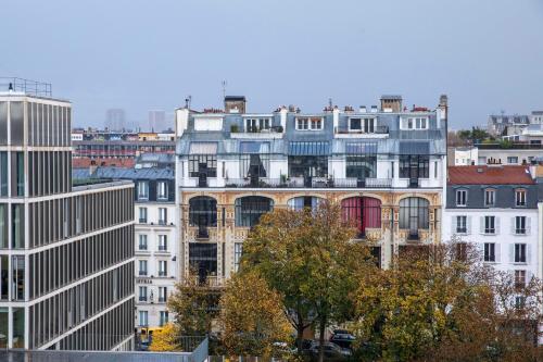 a group of tall buildings in a city at Hôtel Aiglon in Paris