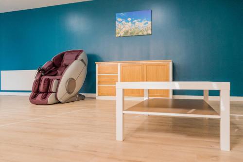 a room with a white table and a chair at English House in Bistriţa