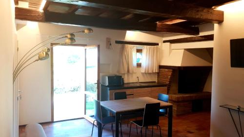 a dining room with a table and a kitchen at Villa Ca' Viola Rimini in Rimini
