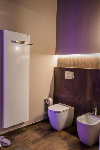 a bathroom with a white toilet and a sink at Villa Ca' Viola Rimini in Rimini