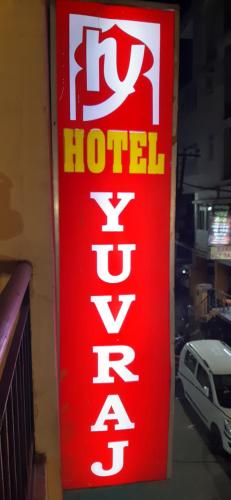 a red hotel sign on the side of a building at Hotel Yuvraj in Patna
