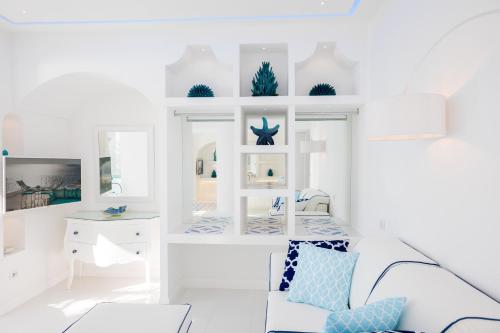 a white living room with a couch and a desk at Villa Fiorentino in Positano
