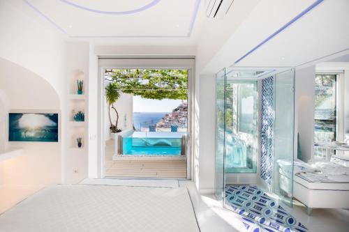 a bedroom with a view of the ocean at Villa Fiorentino in Positano