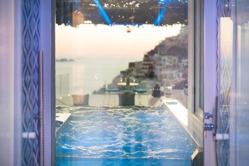a view of a swimming pool from a window at Villa Fiorentino in Positano