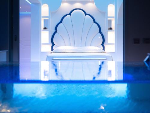 a bedroom with a bed and a pool of water at Villa Fiorentino in Positano