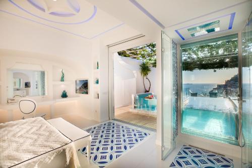 a room with a view of a swimming pool at Villa Fiorentino in Positano