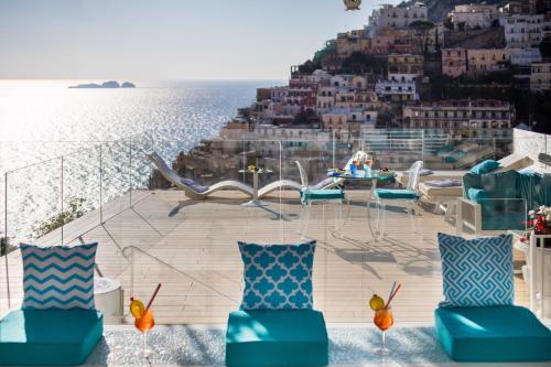 a balcony with chairs and a view of the ocean at Villa Fiorentino in Positano