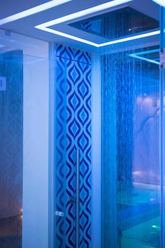 a shower with blue lighting in a bathroom at Villa Fiorentino in Positano