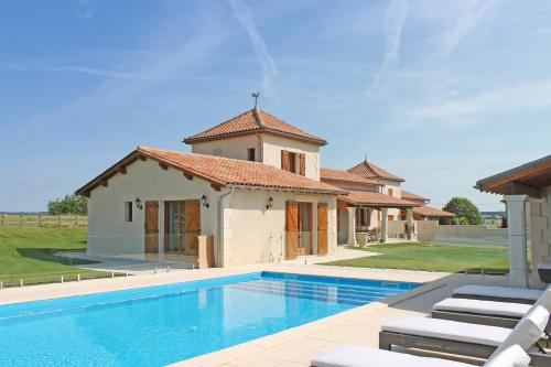 a house with a swimming pool in front of a house at Manoir de Longeveau in Pillac